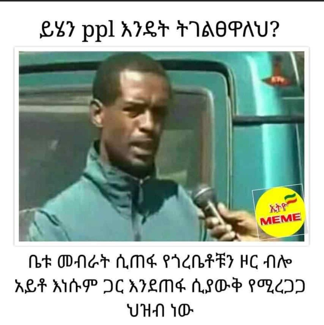 a man in a blue shirt is holding a microphone